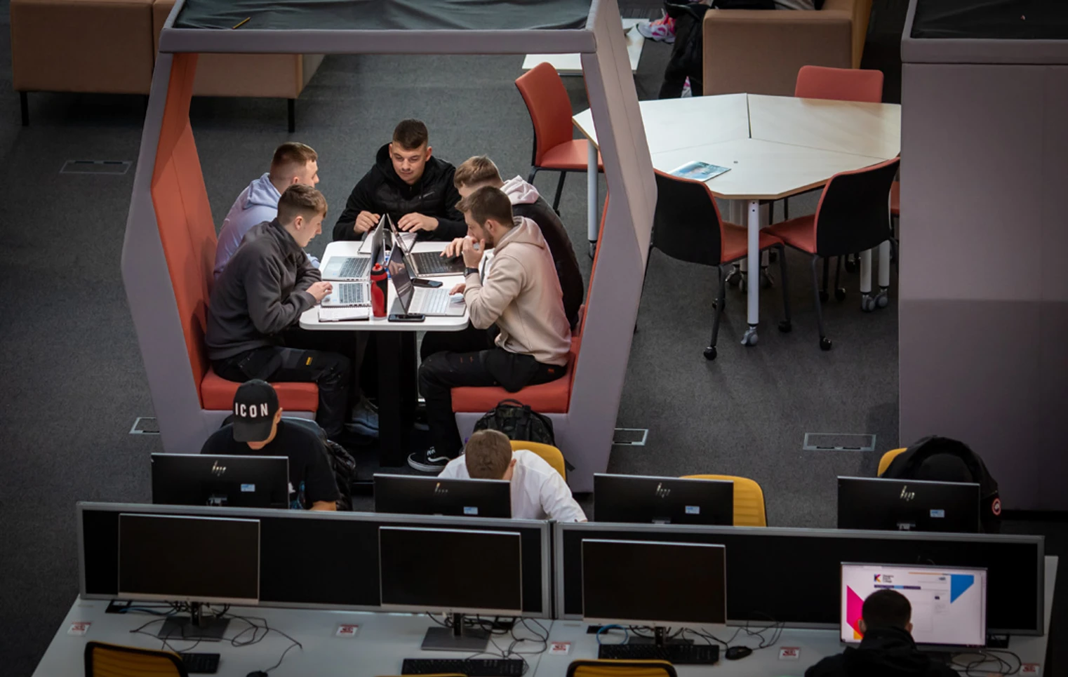 Group of male students working together on laptops in a study pod at Glasgow Kelvin College’s Springburn campus, with others using nearby desktop computers. Group of male students working together on laptops in a study pod at Glasgow Kelvin College’s Springburn campus, with others using nearby desktop computers.