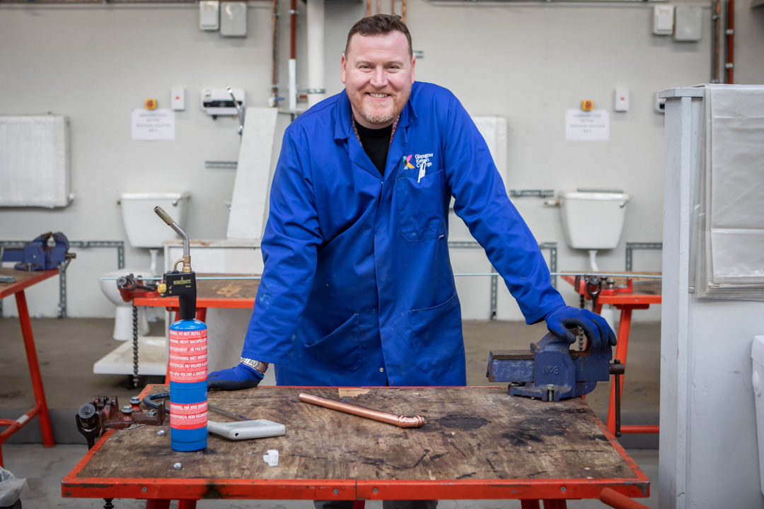 Plumbing lecturer in a practical workshop at Glasgow Kelvin College.