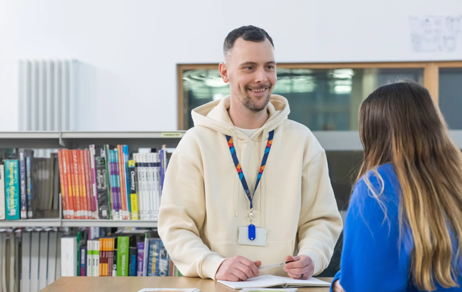 Student receiving support from a staff advisor at a desk in the Glasgow Kelvin College library. Student receiving support from a staff advisor at a desk in the Glasgow Kelvin College library.