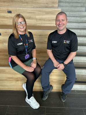 Tracy Leavy and John Montgomery of Glasgow Kelvin College sitting side by side, smiling in a college setting.