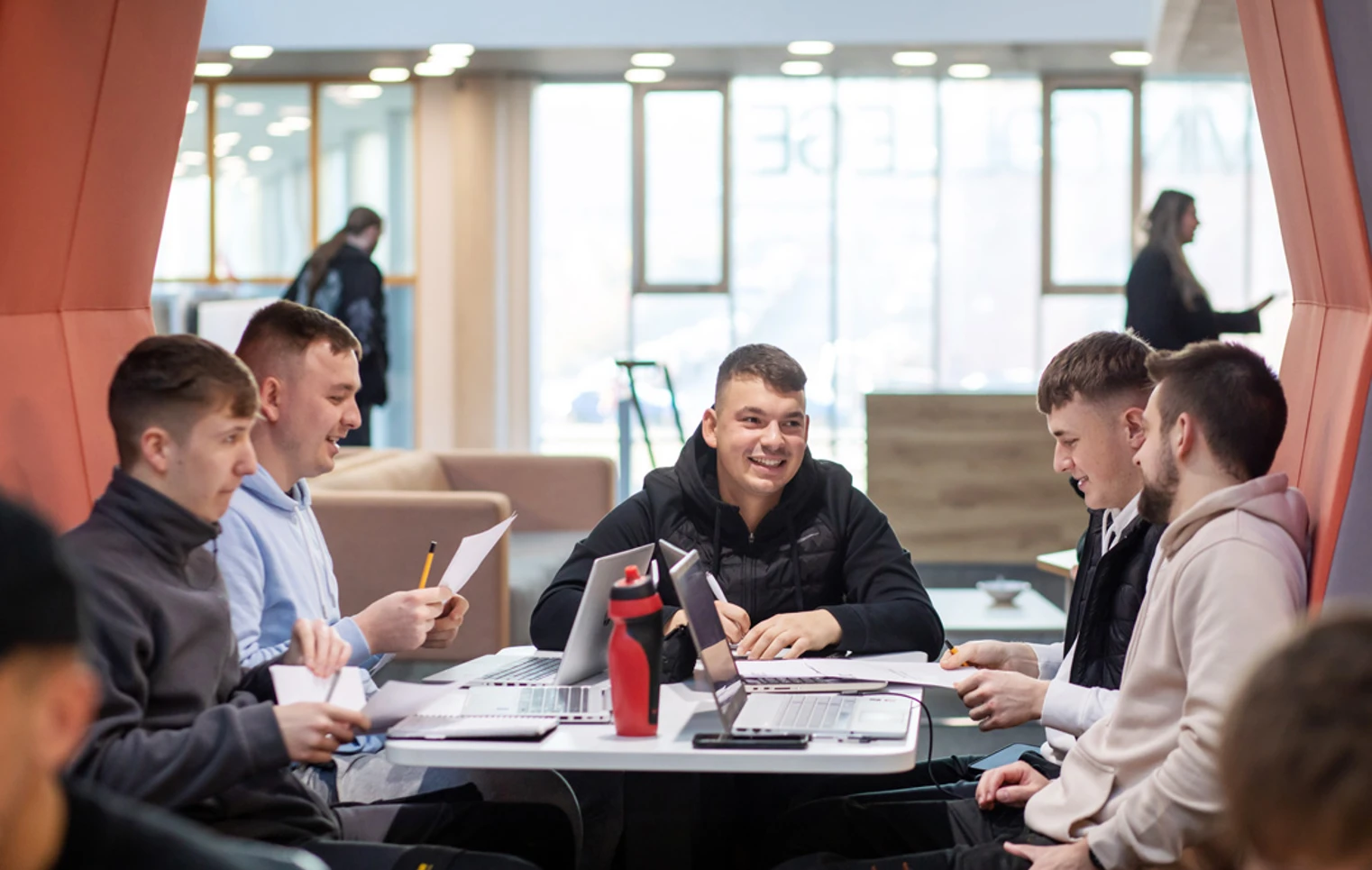 Group of male students working together on laptops and worksheets in a modern study pod at Glasgow Kelvin College Springburn campus Group of male students working together on laptops and worksheets in a modern study pod at Glasgow Kelvin College Springburn campus