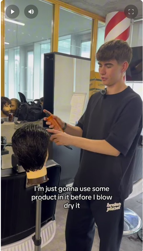 Hairdressing student Marcus demonstrates how to cut and style a modern mullet on a training mannequin at Glasgow Kelvin College.
