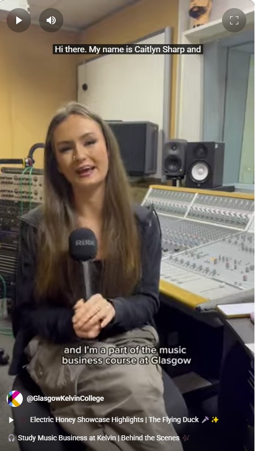 Caitlyn Sharp, a student on the Music Business course at Glasgow Kelvin College, speaks into a microphone in a recording studio, seated in front of a mixing desk.