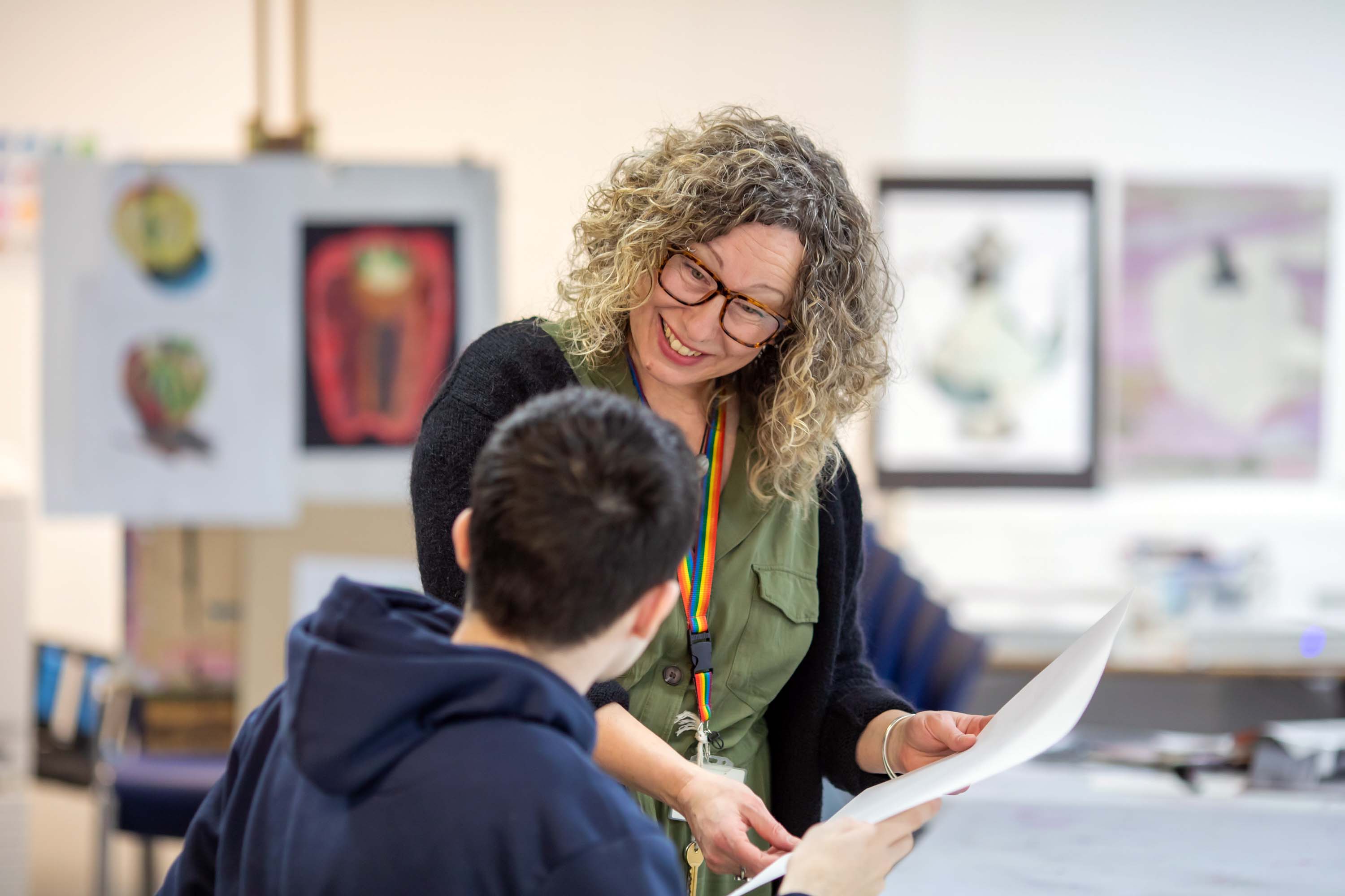 Art and Design lecturer supporting a student with their work at Glasgow Kelvin College.