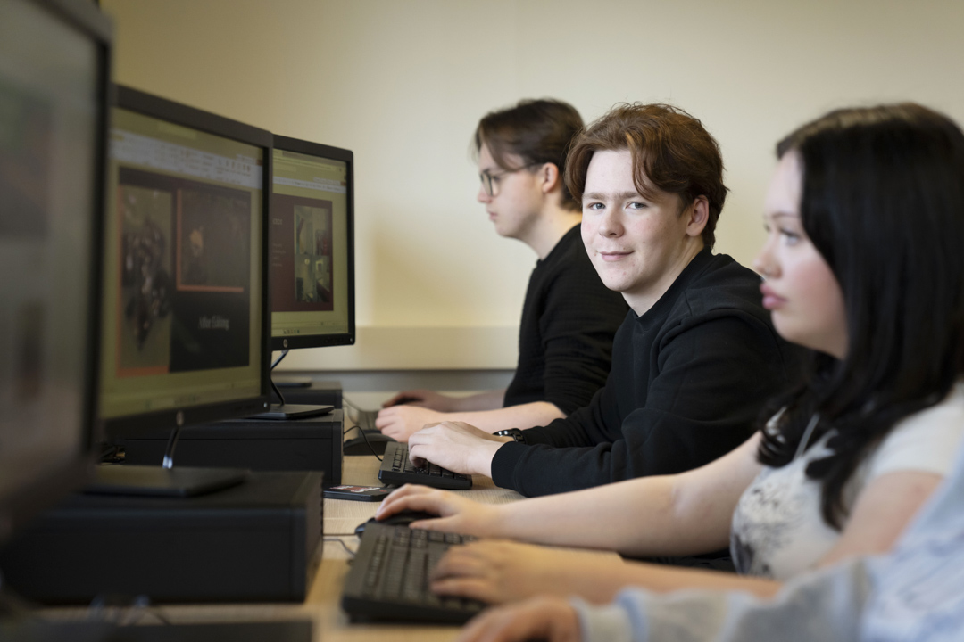 Student seated at a computer workstation during a digital media lesson at Glasgow Kelvin College.