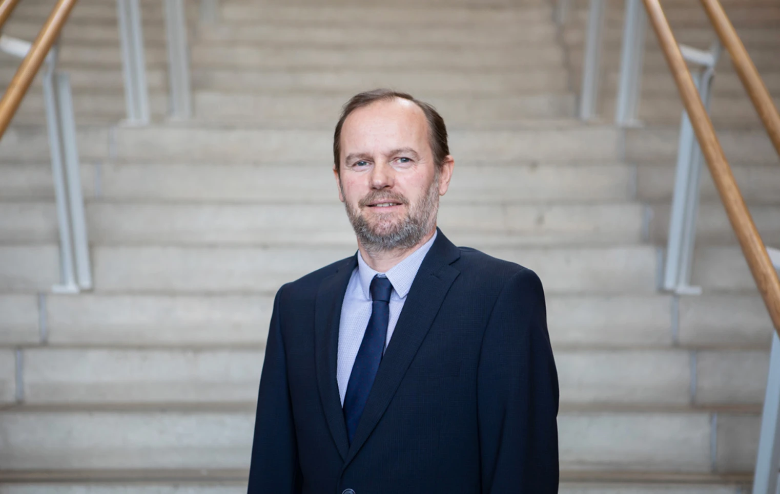 Robin Ashton, Vice Principal of Curriculum and Quality Enhancement at Glasgow Kelvin College, standing on an internal staircase in formal attire Robin Ashton, Vice Principal of Curriculum and Quality Enhancement at Glasgow Kelvin College, standing on an internal staircase in formal attire