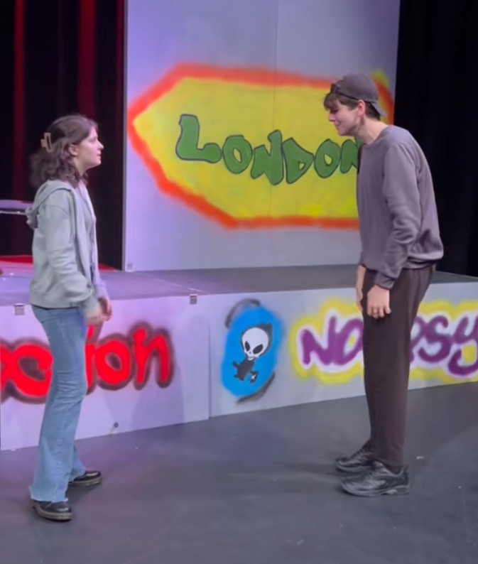 Acting and Performance students performing a scene on stage with colourful set design at Glasgow Kelvin College.