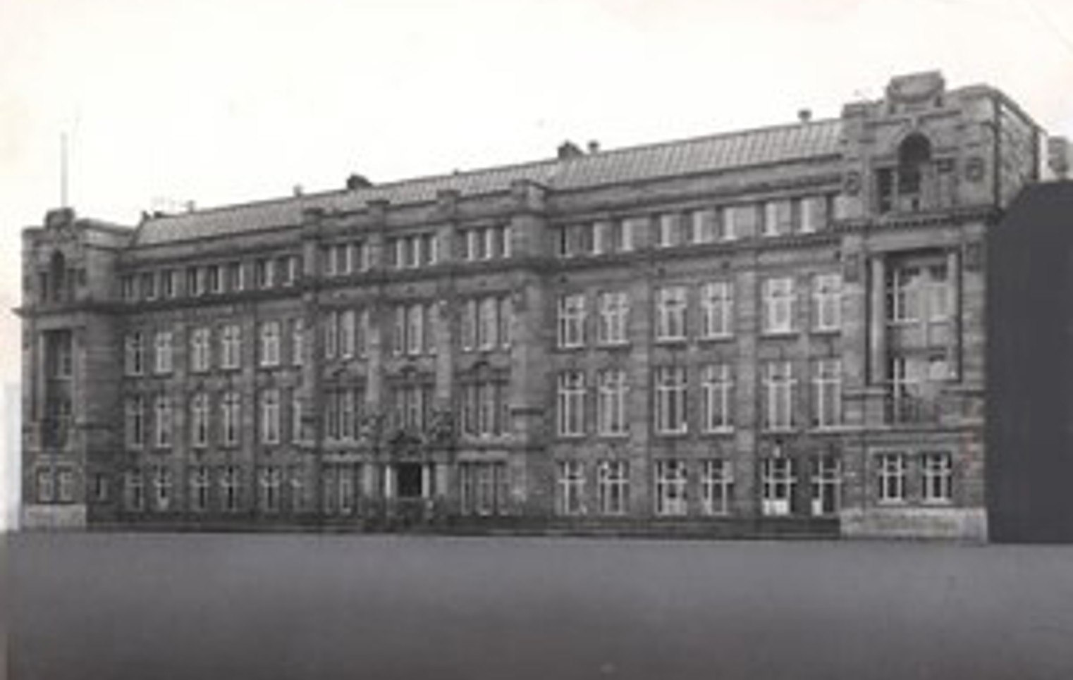 Black and white photograph of the original North Glasgow College building, showcasing its grand early 20th-century architectural style with ornate stonework and large sash windows.